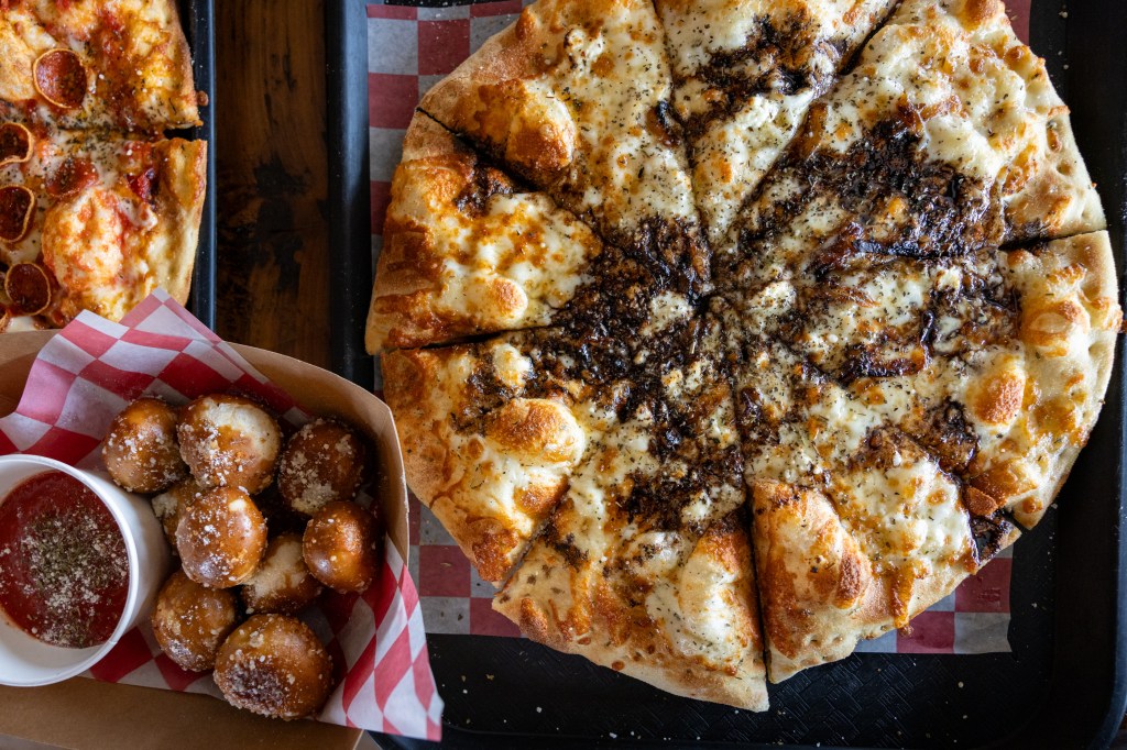 Rosemary goat cheese pizza on tray
