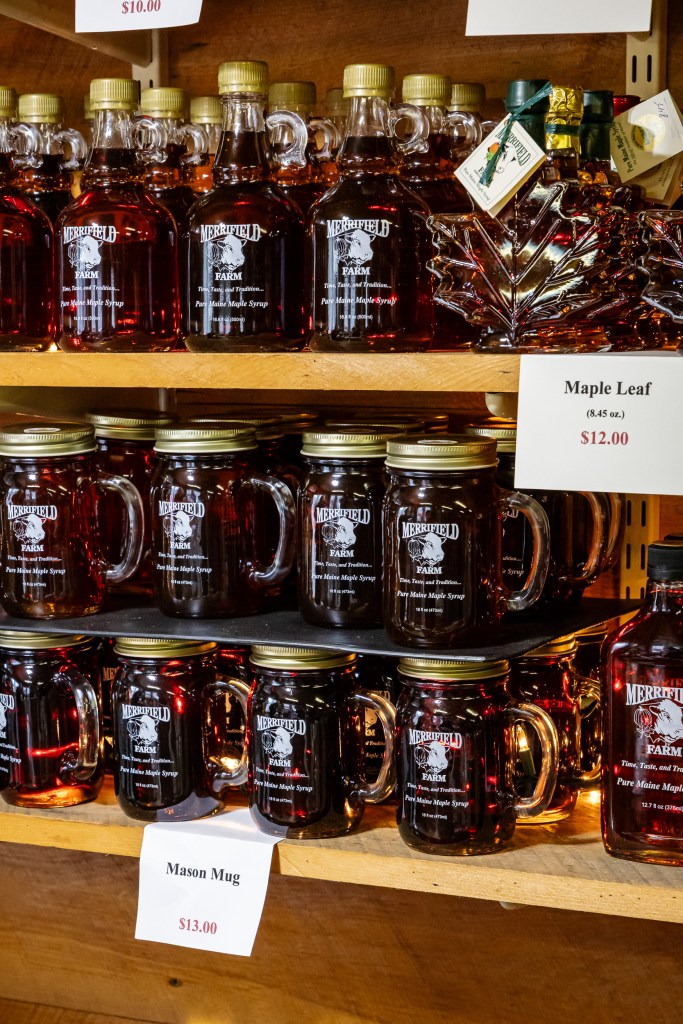 Shelves filled with pure Maine maple syrup bottles inside Merrifield Farm shop