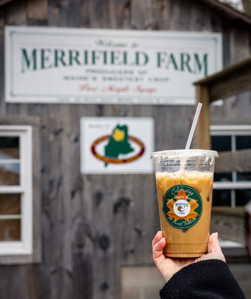 Merrifield Farm sign in Gorham Maine during Maine Maple Sunday with iced maple coffee