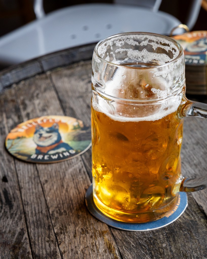 Beer mug with Belleflower coaster on table