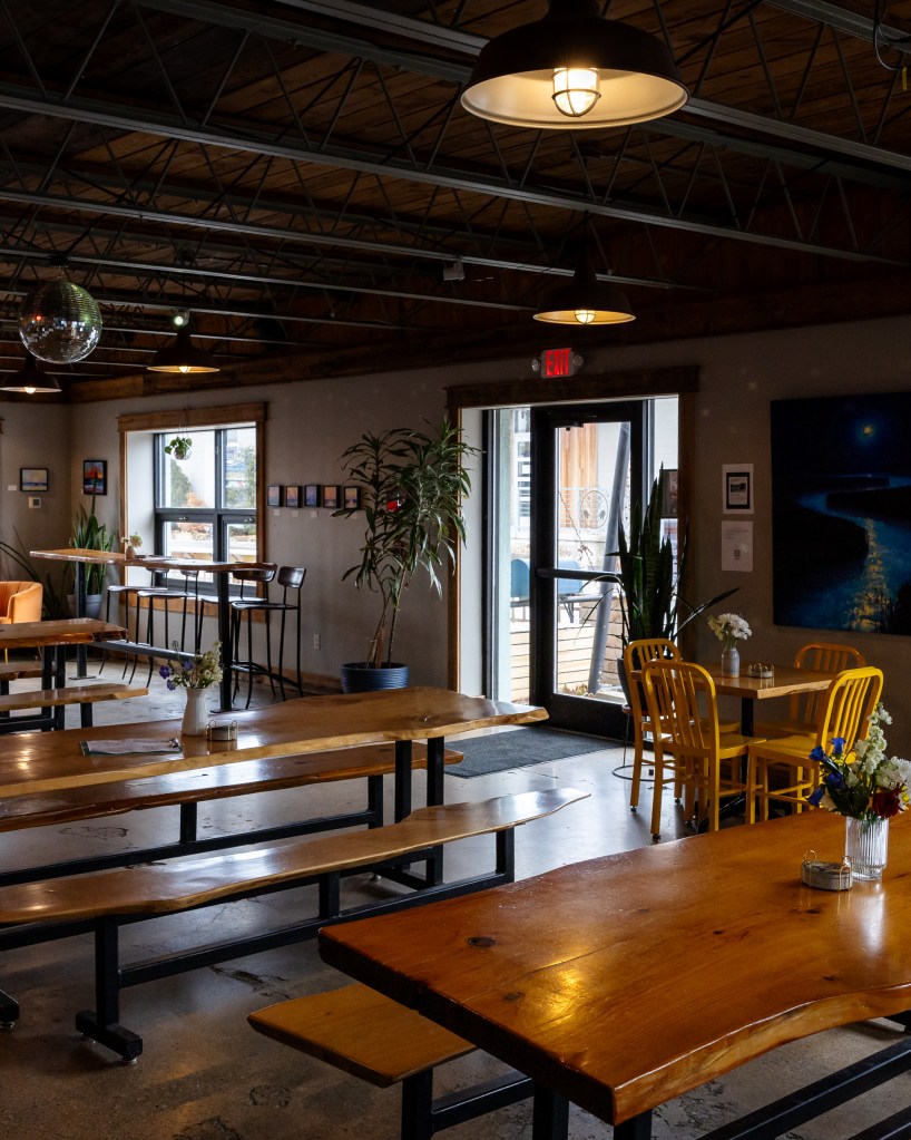 Wide interior seating with long wooden tables