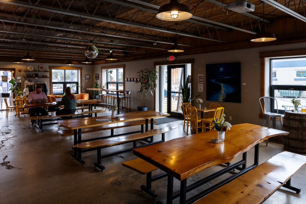 Wide interior seating with long wooden tables