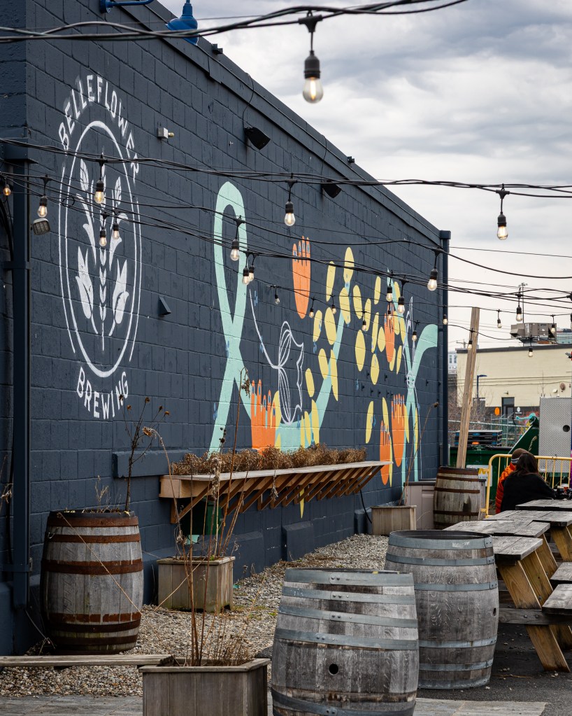 Belleflower Brewing mural with outdoor seating and string lights