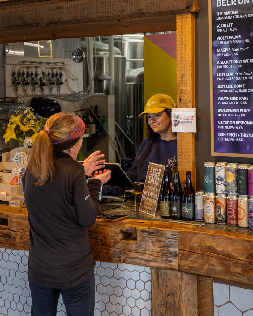 Taproom counter with staff and customer interaction