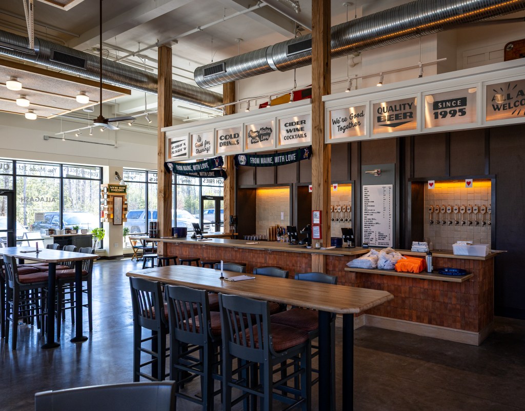 Wide interior view of Allagash Bungalow with bar and seating area
