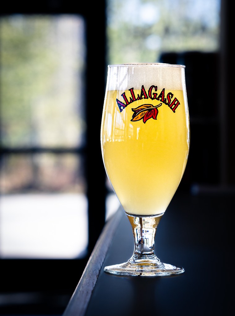 Allagash branded glass with condensation and light reflections
